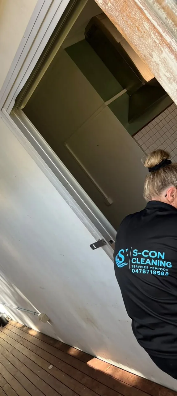 A member of the S-Con family team at work in a branded teal-and-black shirt